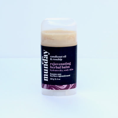 Rejuvenating herbal balm with candlenut oil and rosehip, packaged in a twist-up stick form for on-the-go